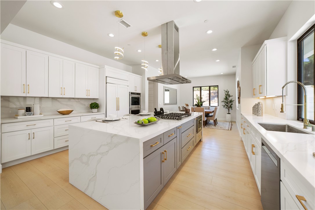 2027 Vía Monserate Fallbrook, CA 92028 - Photo 47 of 66 a large kitchen with stainless steel appliances kitchen island granite countertop a sink and cabinets