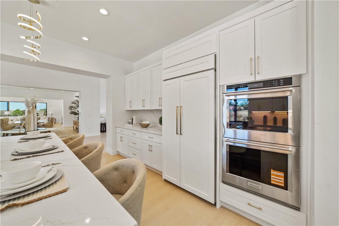 2027 Vía Monserate Fallbrook, CA 92028 - Photo 48 of 66 a kitchen with granite countertop white cabinets and white appliances