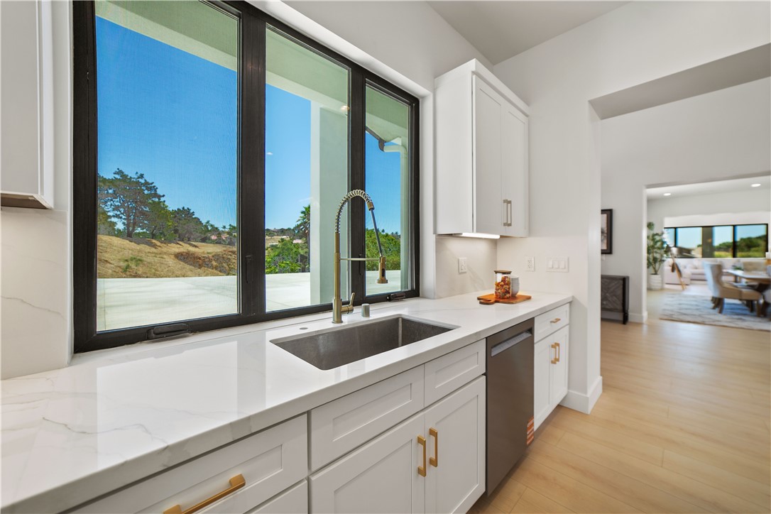 2027 Vía Monserate Fallbrook, CA 92028 - Photo 51 of 66 a kitchen with a sink and large window