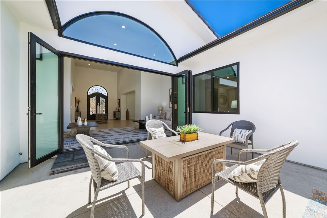 2027 Vía Monserate Fallbrook, CA 92028 - Photo 56 of 66 a dining room with a wooden table and chairs