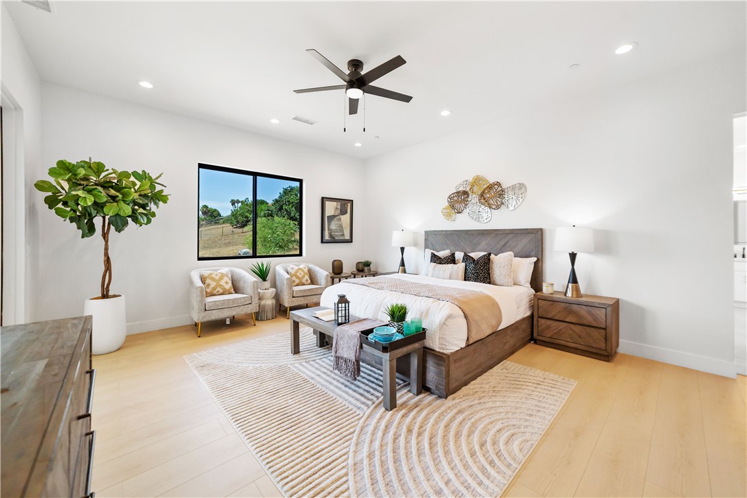 2027 Vía Monserate Fallbrook, CA 92028 - Photo 9 of 66 a bedroom with a bed and a chandelier