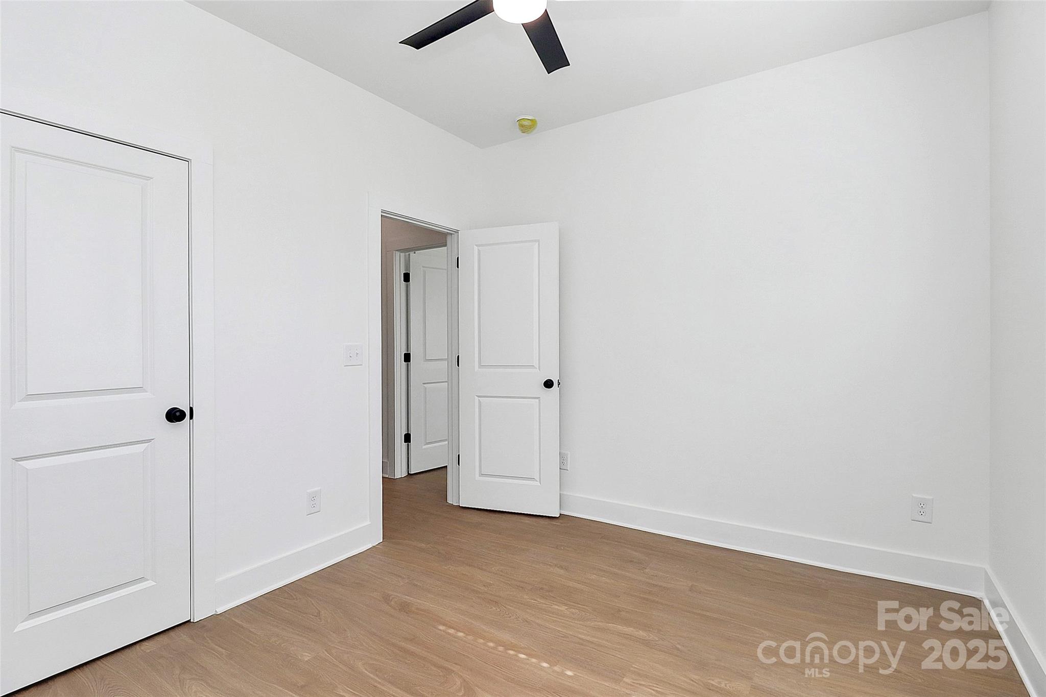 6154 Lowder Road Salisbury, NC 28147 - Photo 14 of 36 an empty room with a ceiling fan and wooden floor