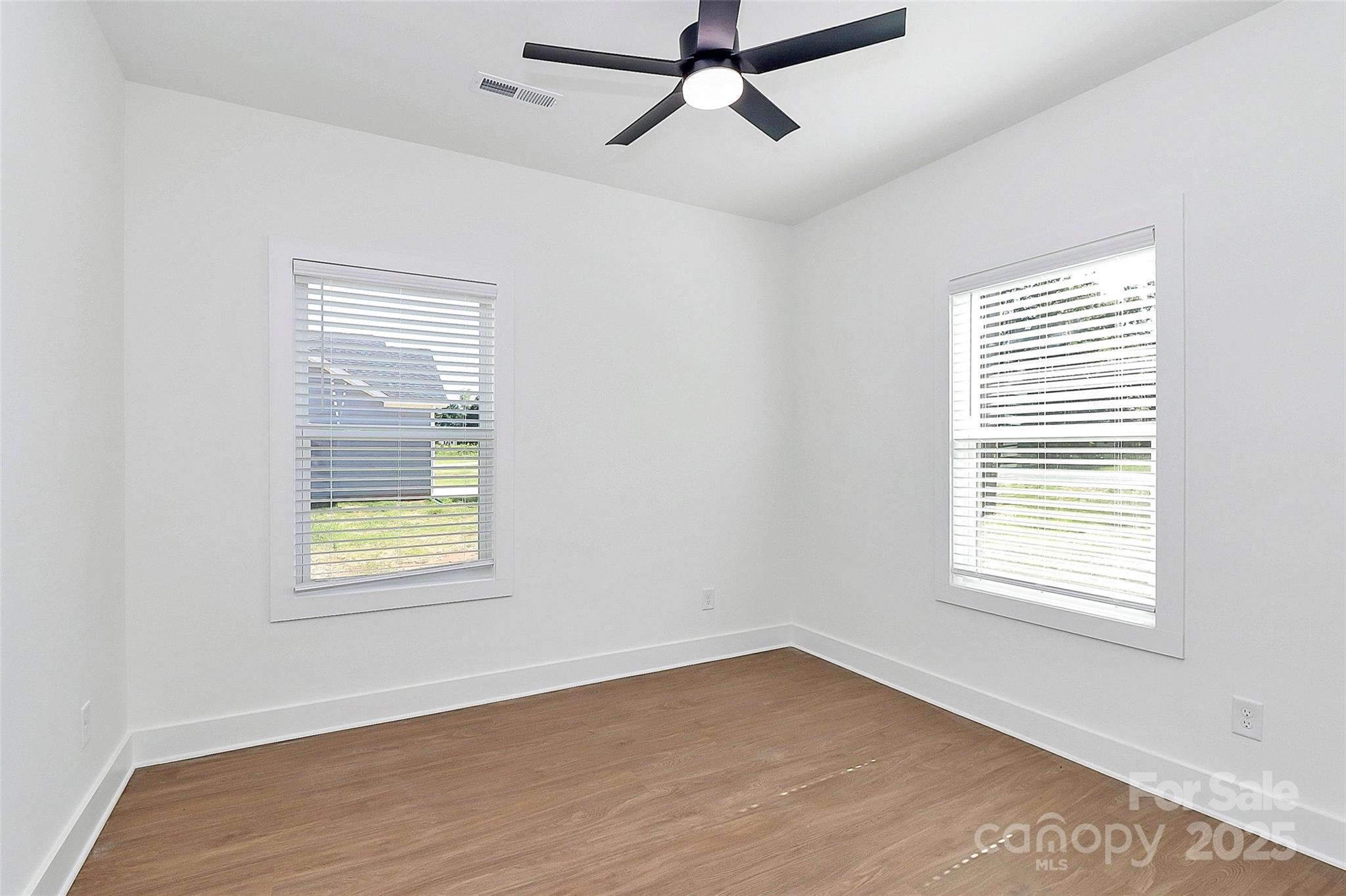6154 Lowder Road Salisbury, NC 28147 - Photo 19 of 36 a view of an empty room with wooden floor and a window