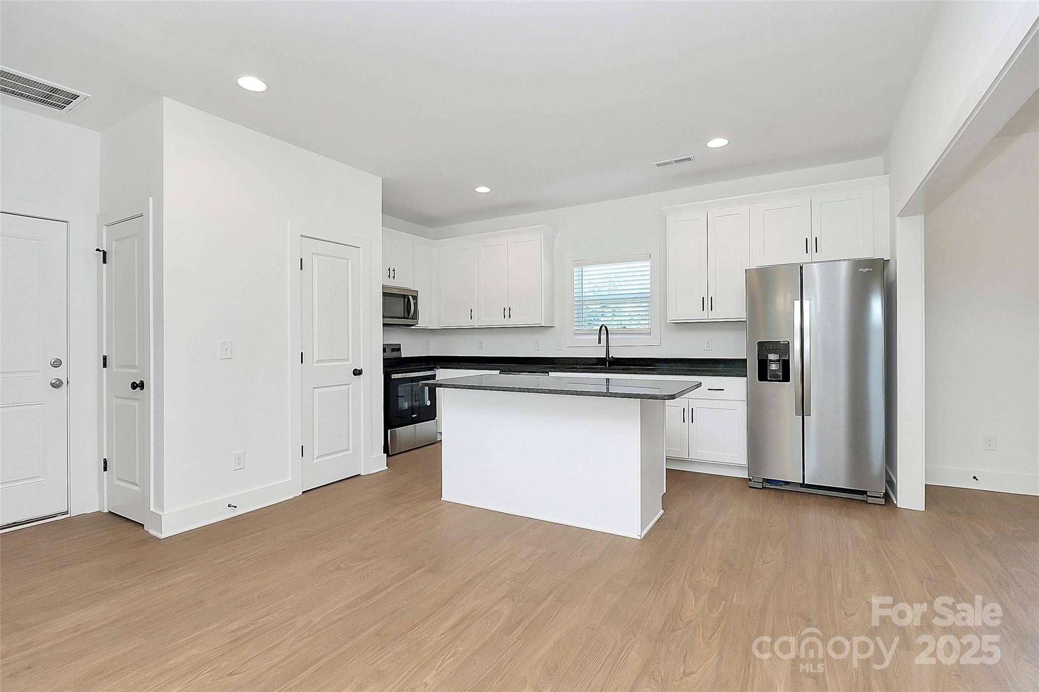 6154 Lowder Road Salisbury, NC 28147 - Photo 6 of 36 a kitchen with stainless steel appliances granite countertop a refrigerator sink and white cabinets