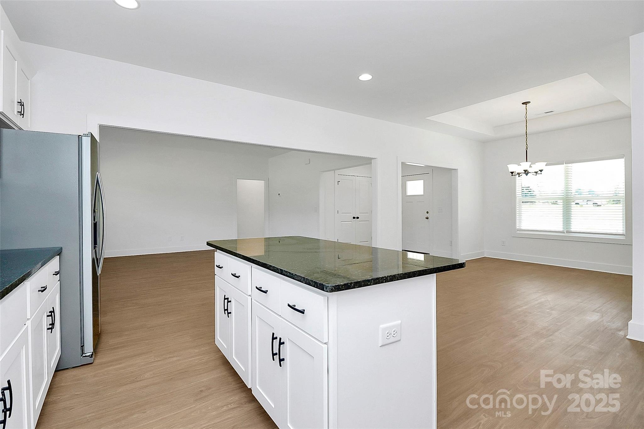 6154 Lowder Road Salisbury, NC 28147 - Photo 7 of 36 a kitchen with granite countertop white cabinets and window