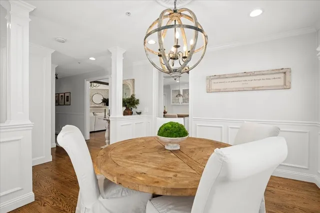 a kitchen with a table and a chandelier