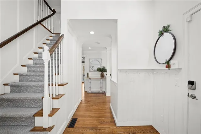 a view of a hallway with wooden floor and entryway