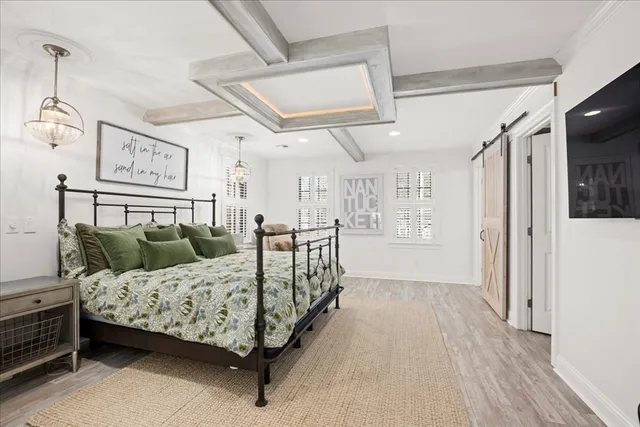 a bedroom with a bed couch and a window