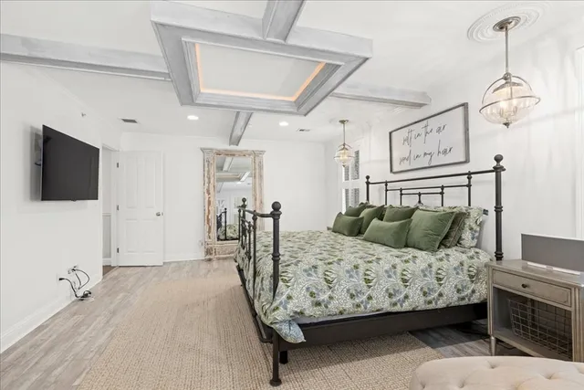 a bedroom with a bed window and flat screen tv