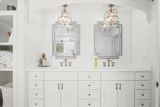 a bathroom with a sink vanity and mirror