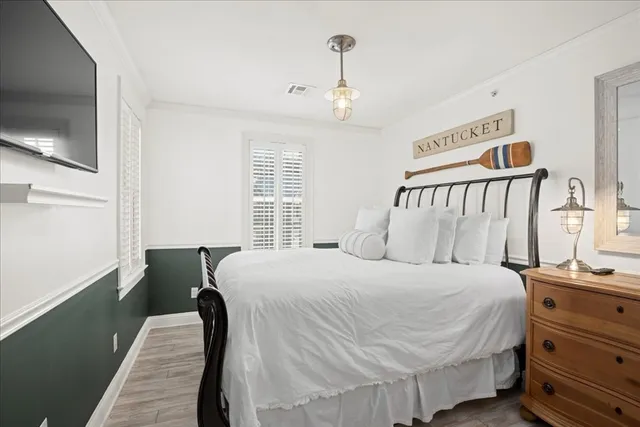 a bedroom with a bed and a tv on the dresser