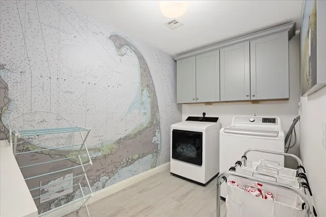 a view of a storage and utility room with washer and dryer