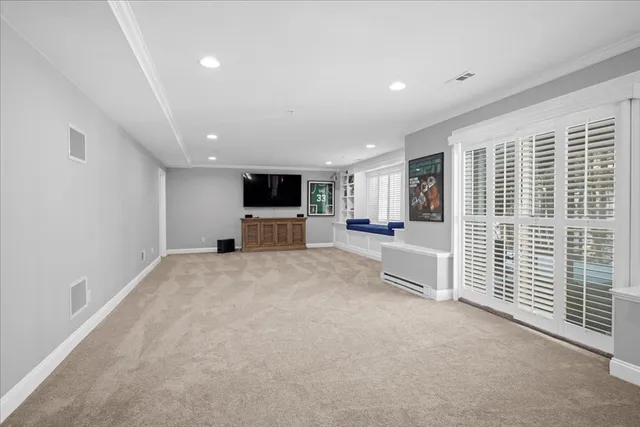 a view of livingroom with an empty space and a refrigerator