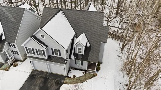 a patio with table and chairs and potted plants