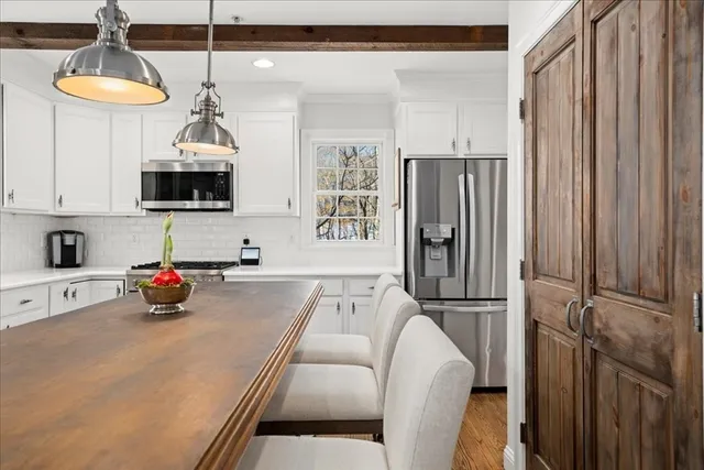 a kitchen with stainless steel appliances a refrigerator a sink and a stove