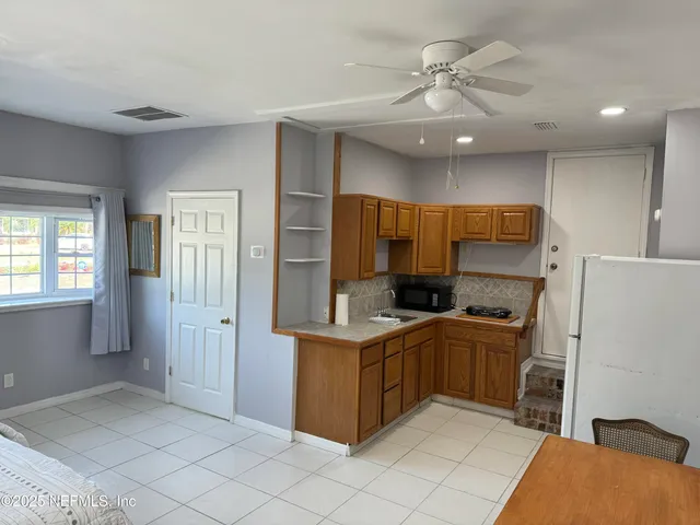 a kitchen with a cabinets and white stainless steel appliances