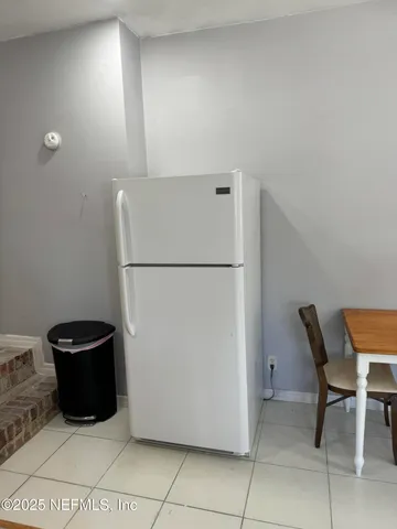 a refrigerator freezer sitting in a kitchen