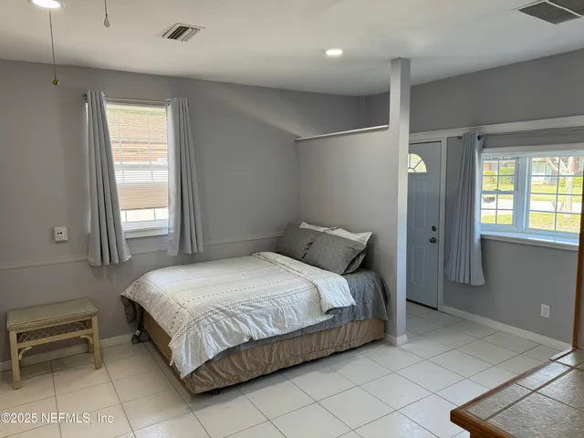 a bedroom with a bed and a window