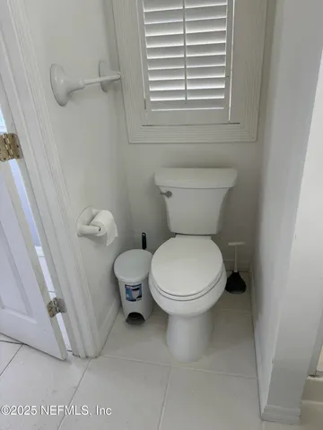 a white toilet sitting next to a bathroom sink