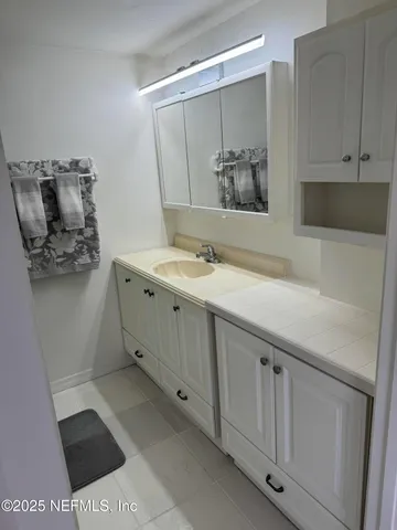 a bathroom with a sink and a mirror