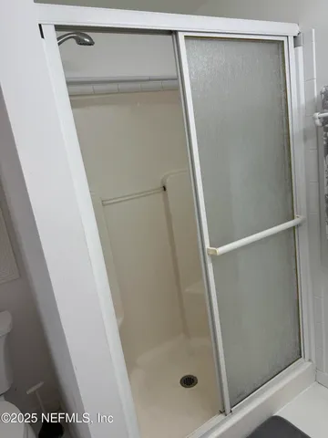 a bathroom with a glass door shower