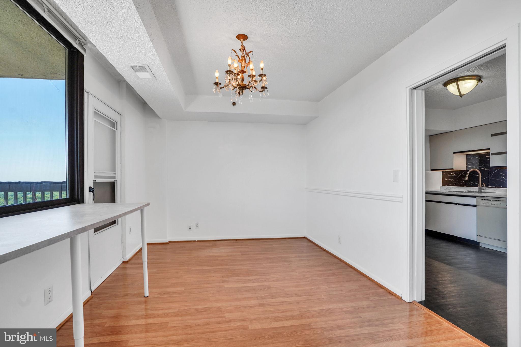 5501 Seminary Road, Unit 1908S Falls Church, VA 22041 - Photo 20 of 43 a view of a hallway with wooden floor and a kitchen