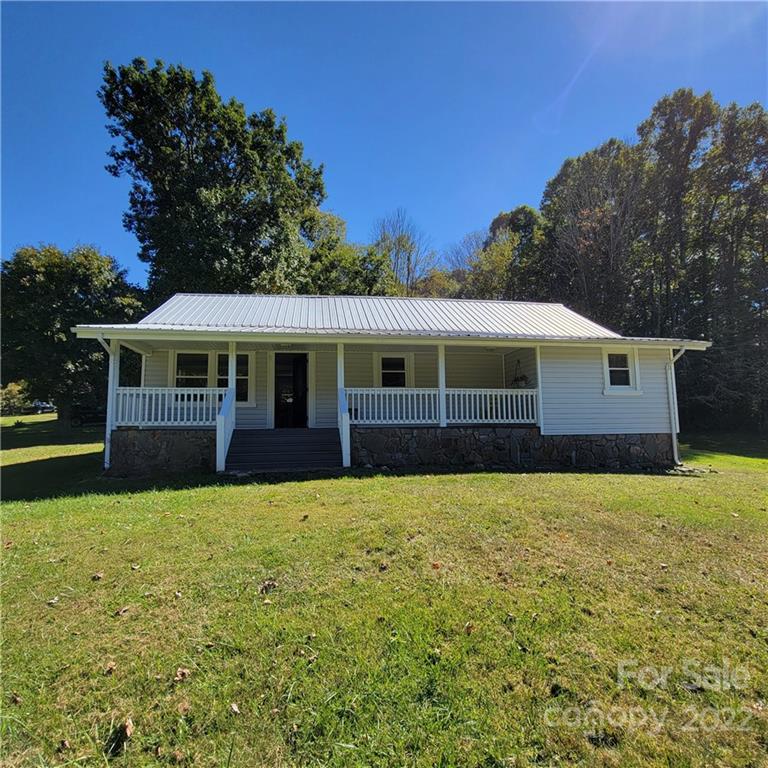 26 Possum Trot Road Bakersville, NC 28705 - Photo 1 of 22 a front view of house with yard and green space