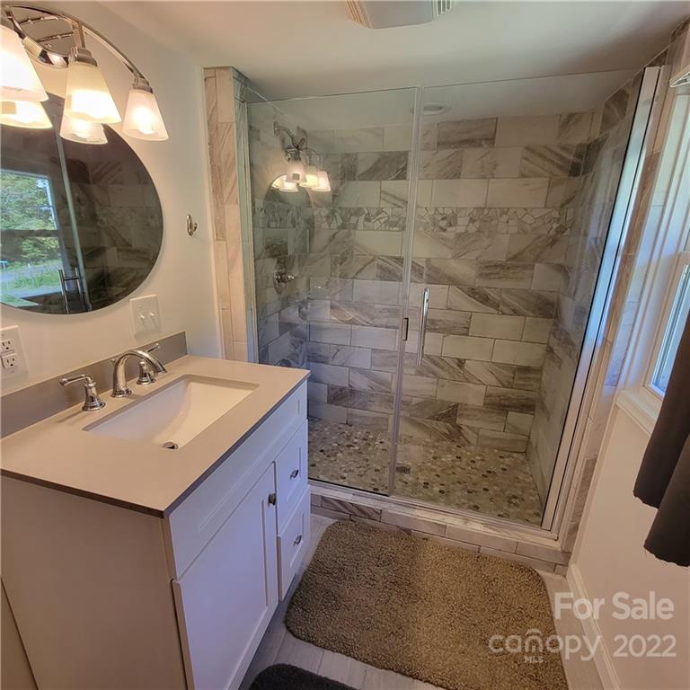 26 Possum Trot Road Bakersville, NC 28705 - Photo 18 of 22 a bathroom with a sink and a mirror