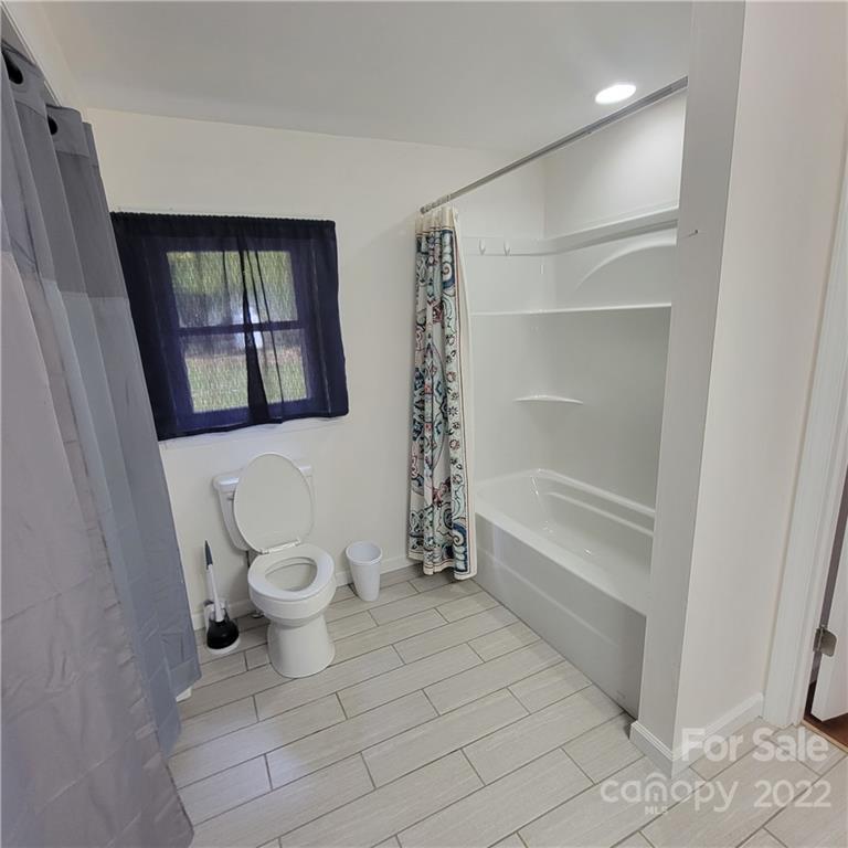 26 Possum Trot Road Bakersville, NC 28705 - Photo 20 of 22 a bathroom with a toilet and a shower