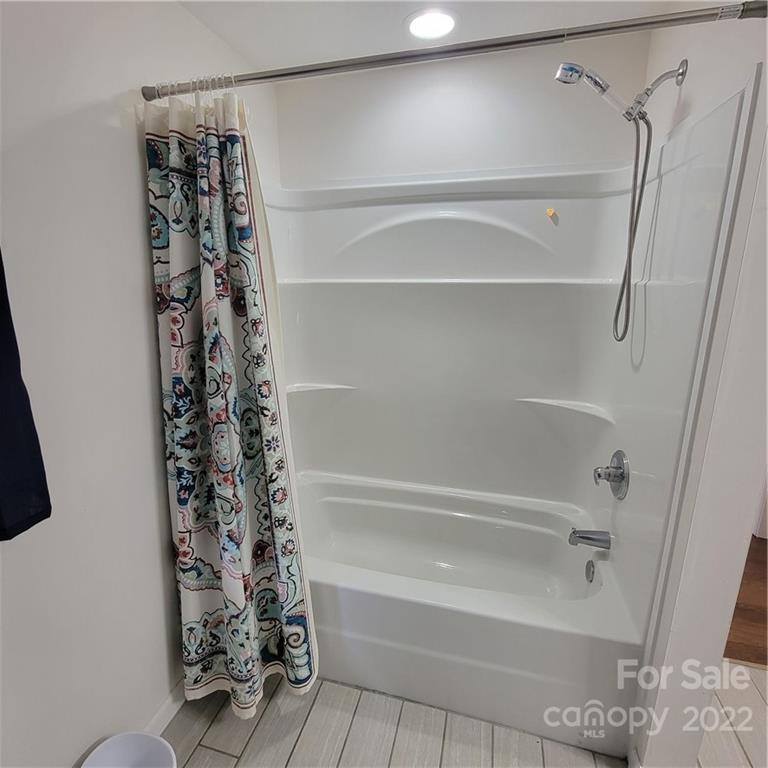 26 Possum Trot Road Bakersville, NC 28705 - Photo 21 of 22 a bathroom with a bathtub and shower