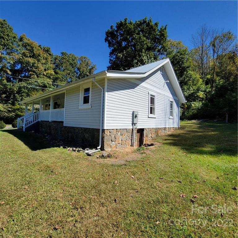26 Possum Trot Road Bakersville, NC 28705 - Photo 3 of 22 a view of a house with yard and garden