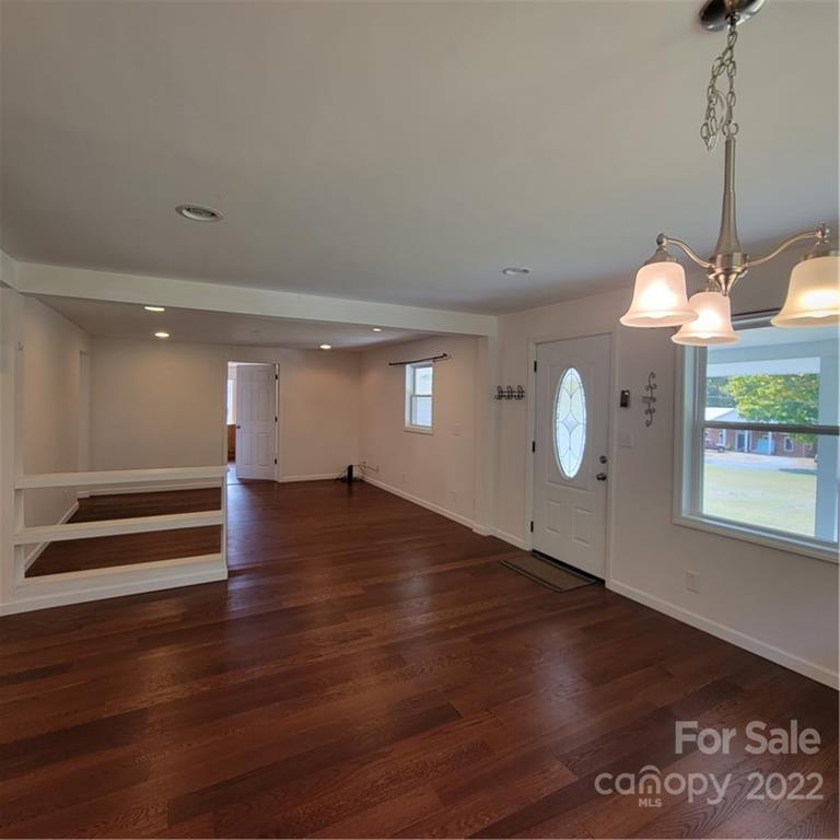 26 Possum Trot Road Bakersville, NC 28705 - Photo 9 of 22 a view of empty room with wooden floor and fan