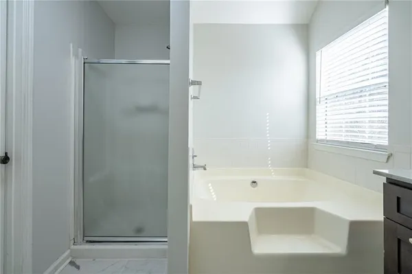 a bathroom with a bathtub and a shower