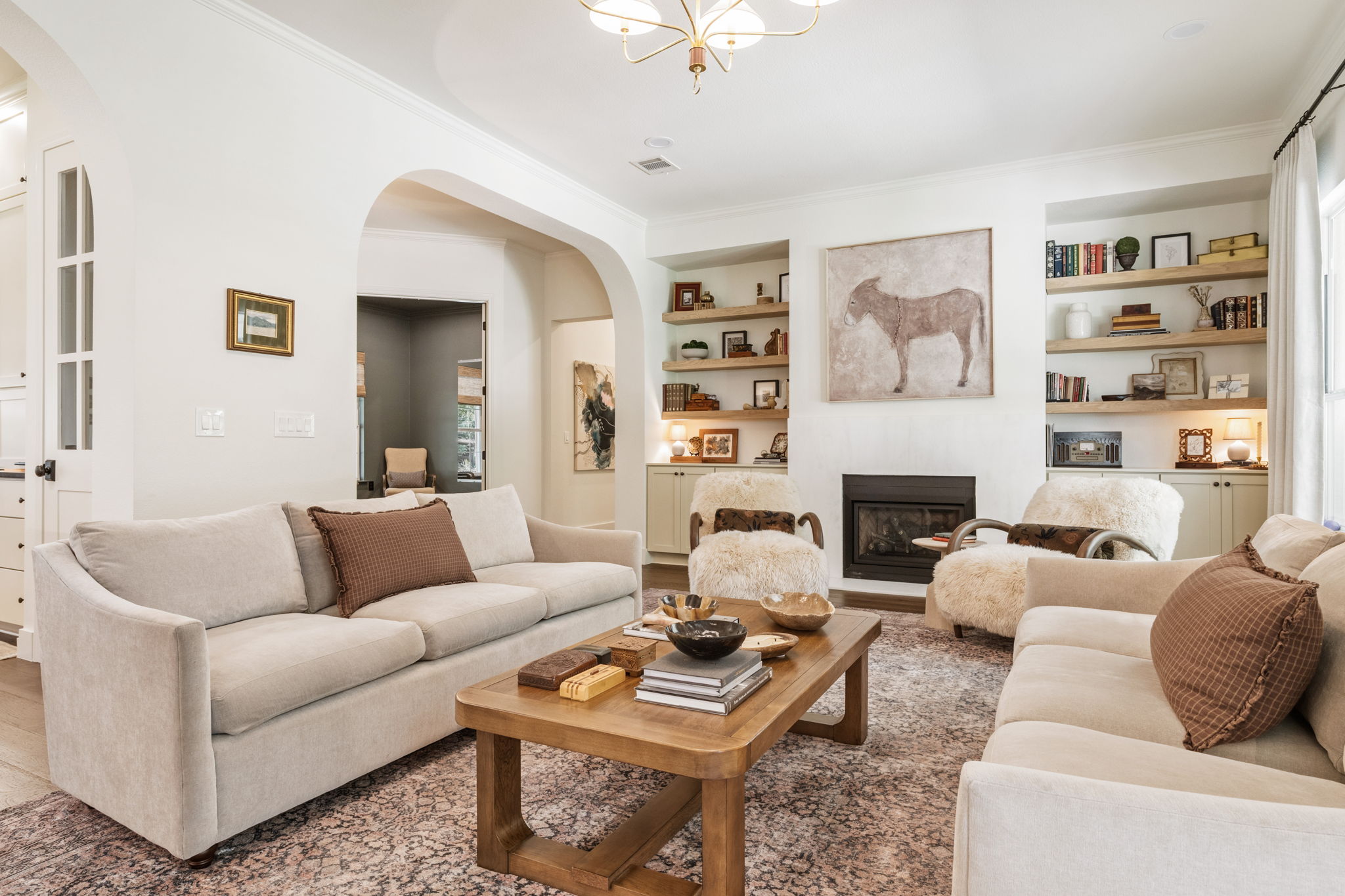 118 Cold Springs Drive Georgetown, TX 78633 - Photo 8 of 40 Step into this luminous gathering area featuring built-in shelving, a fireplace, and elegant hardwood flooring.