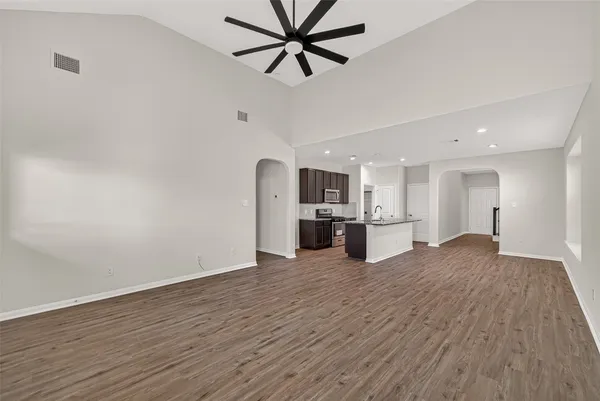 a kitchen with granite countertop kitchen island stainless steel appliances refrigerator microwave and stove