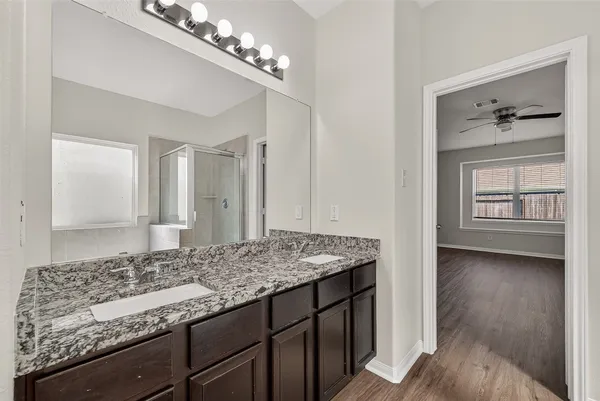 a bathroom with a tub sink and mirror