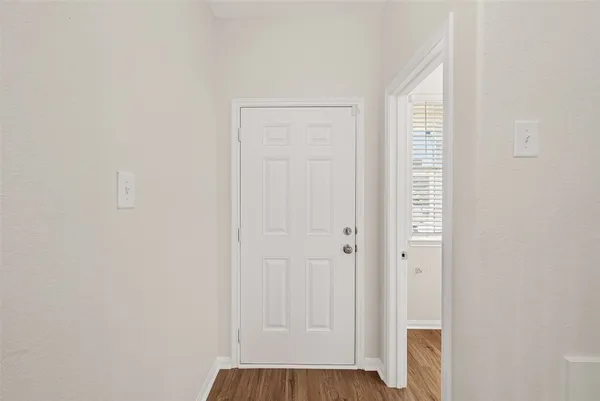 a view of staircase with white walls and a window