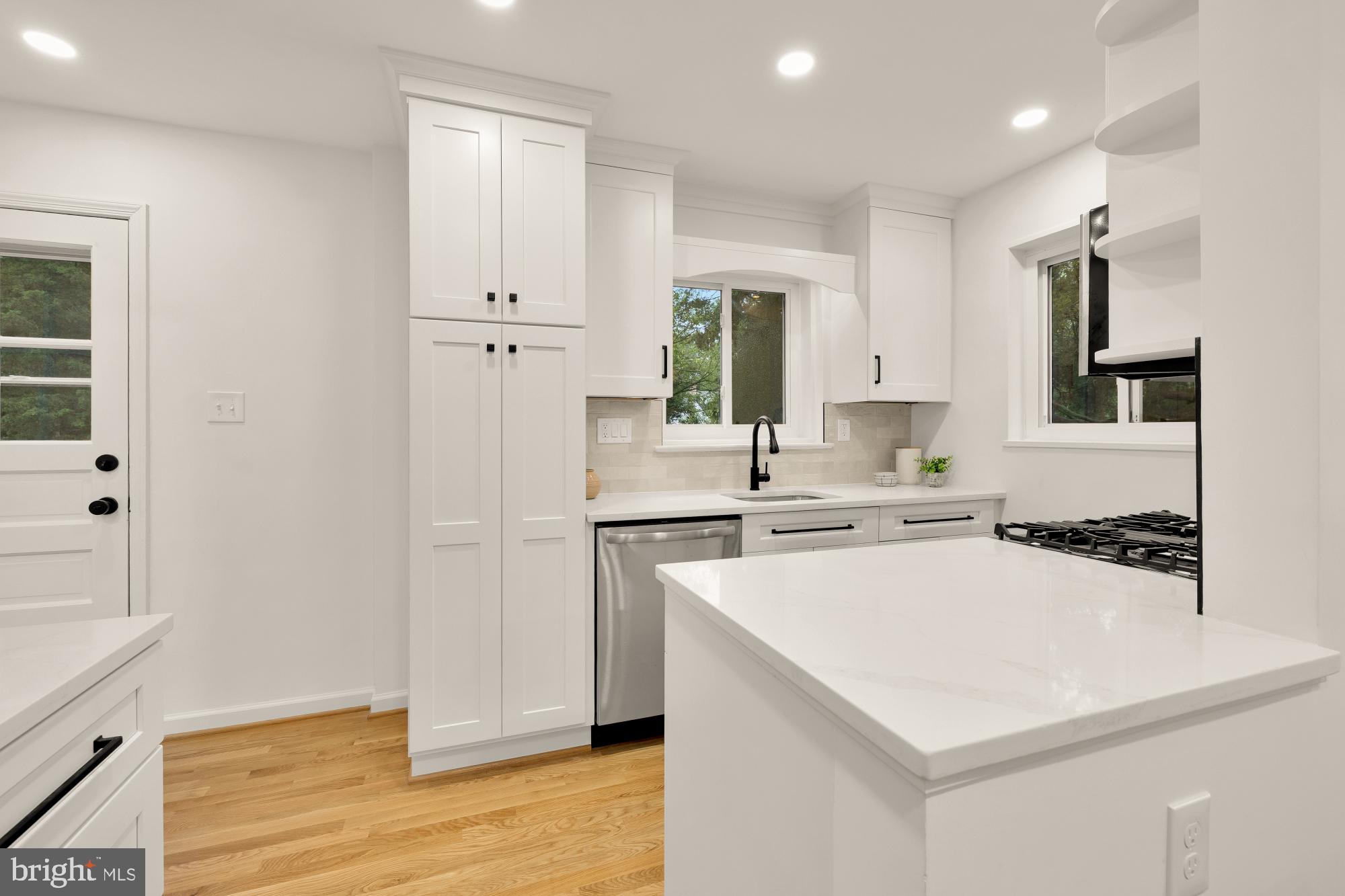 6232 18th Road North Arlington, VA 22205 - Photo 11 of 43 a kitchen with a sink a stove a refrigerator and white cabinets