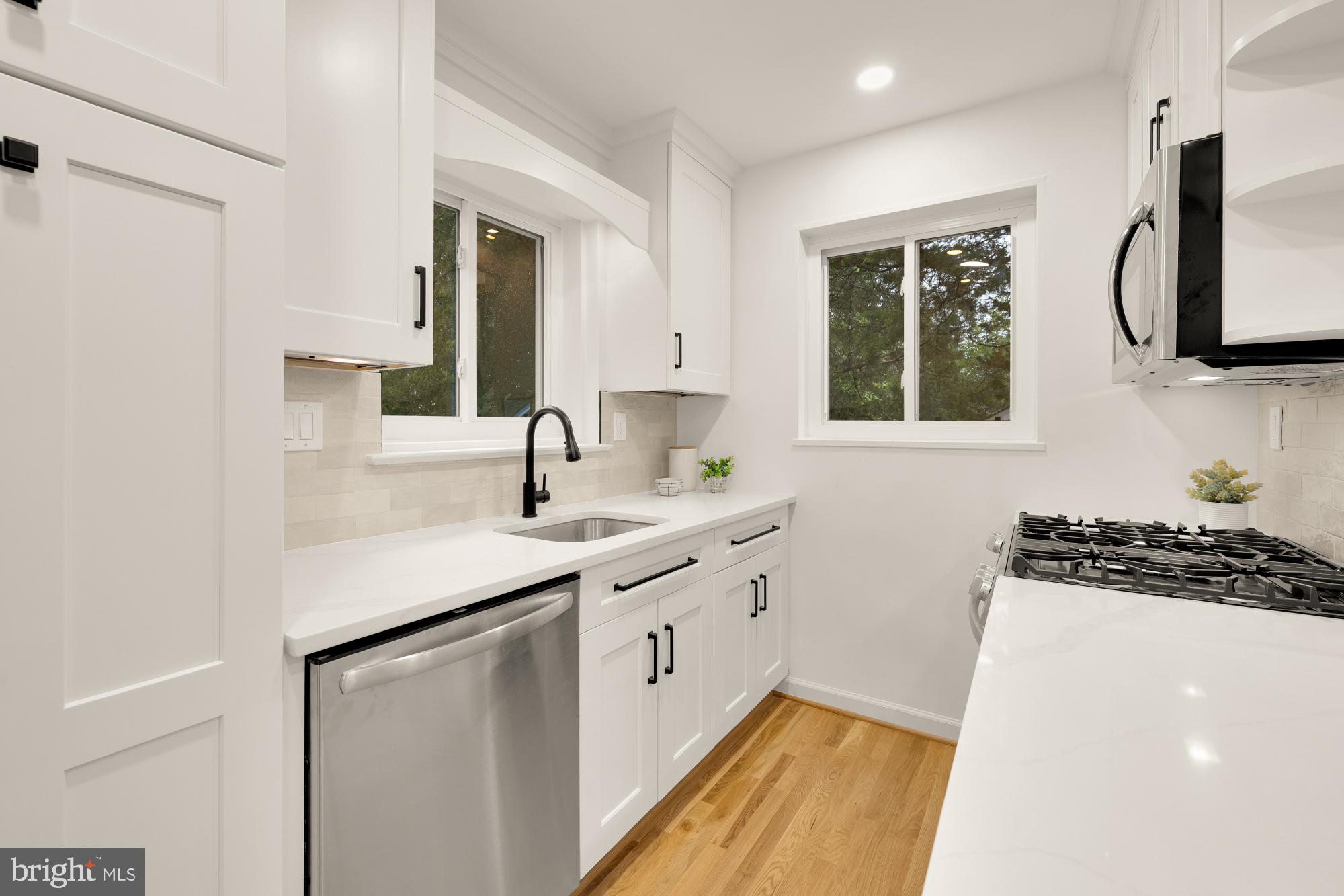 6232 18th Road North Arlington, VA 22205 - Photo 12 of 43 a kitchen with a sink stove and microwave