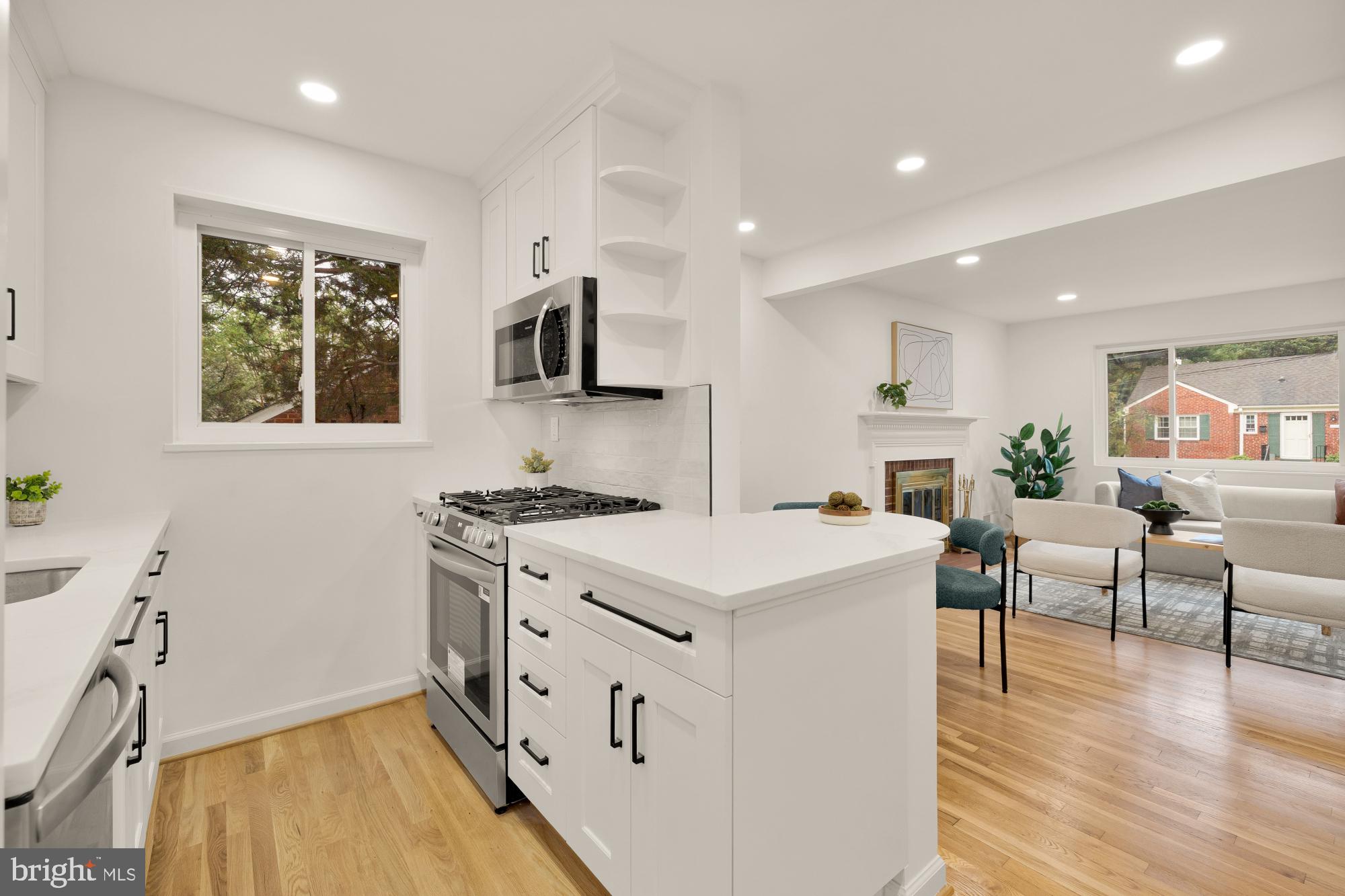 6232 18th Road North Arlington, VA 22205 - Photo 14 of 43 a kitchen with stainless steel appliances granite countertop a stove top oven a sink a dining table and chairs with wooden floor