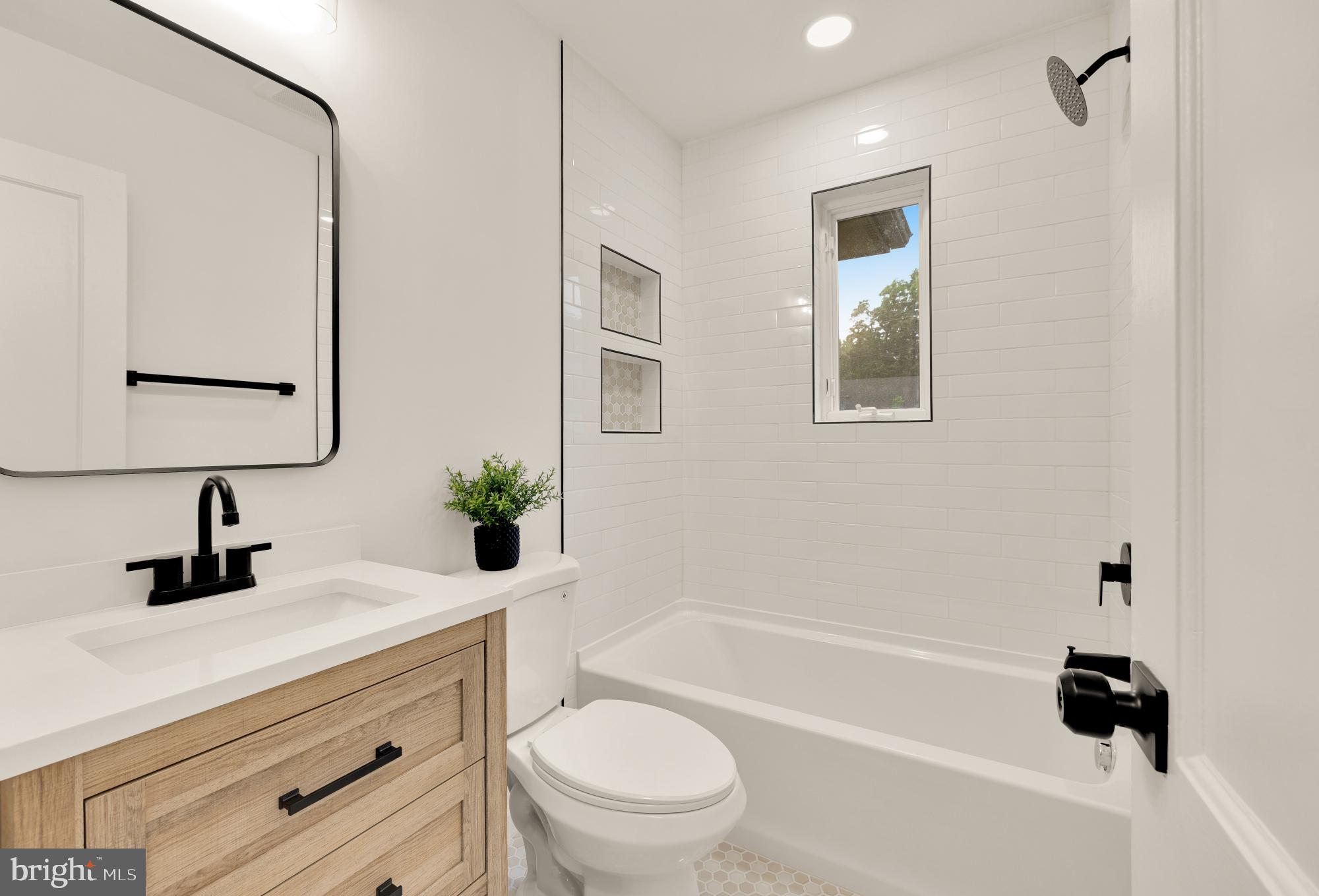 6232 18th Road North Arlington, VA 22205 - Photo 16 of 43 a bathroom with a bathtub shower sink vanity mirror and toilet