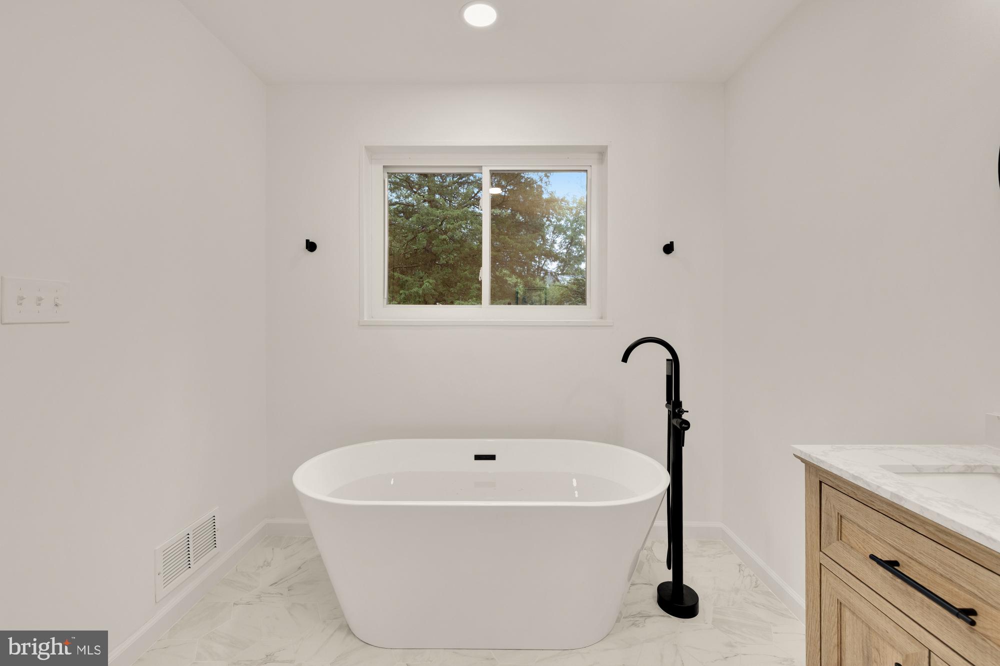 6232 18th Road North Arlington, VA 22205 - Photo 22 of 43 a white bath tub sitting in a bathroom