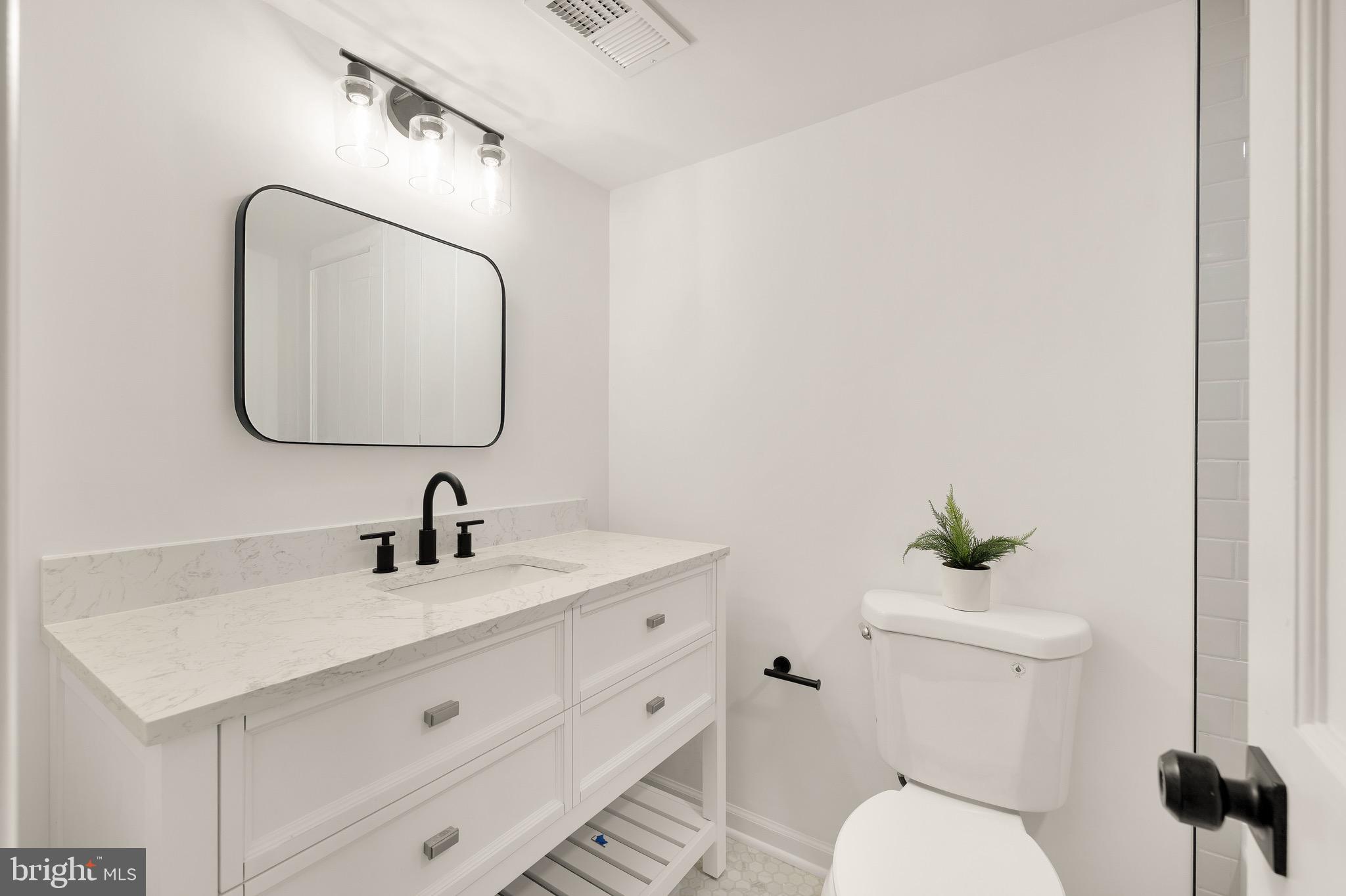 6232 18th Road North Arlington, VA 22205 - Photo 32 of 43 a bathroom with a toilet sink and mirror