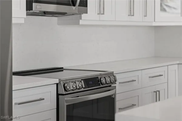 a stove top oven sitting inside of a kitchen