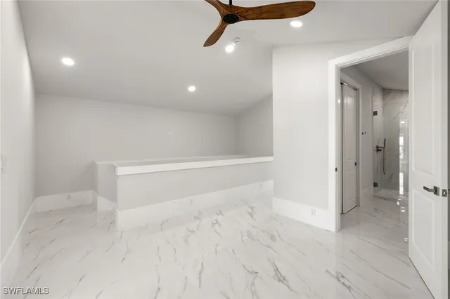 a view of a balcony with a floor to ceiling window and wooden floor