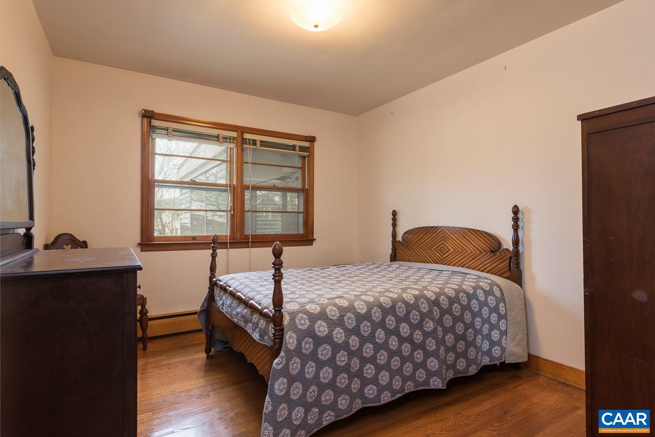 516 Ridge Street Charlottesville, VA 22902 - Photo 12 of 13 a bedroom with a bed and a table
