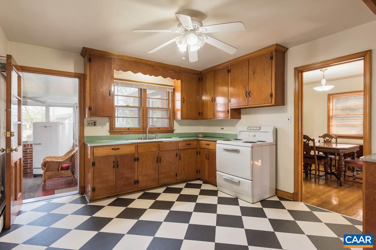 516 Ridge Street Charlottesville, VA 22902 - Photo 5 of 13 a kitchen with a checkered floor and white cabinets