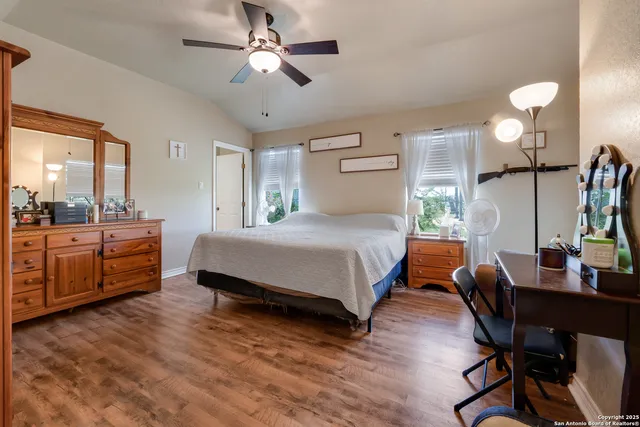 a bedroom with a bed window and a table