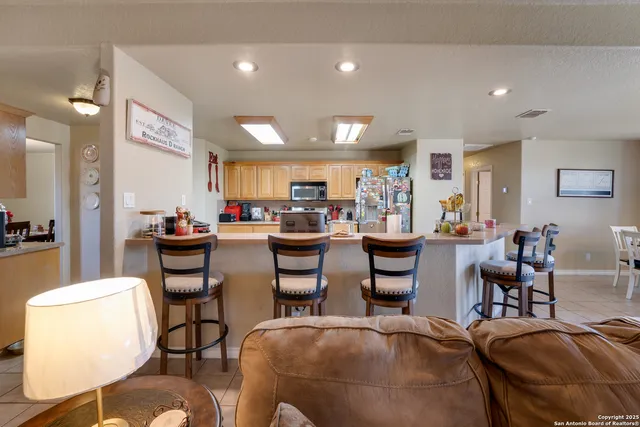 a living room with lots of furniture and a large mirror with furniture