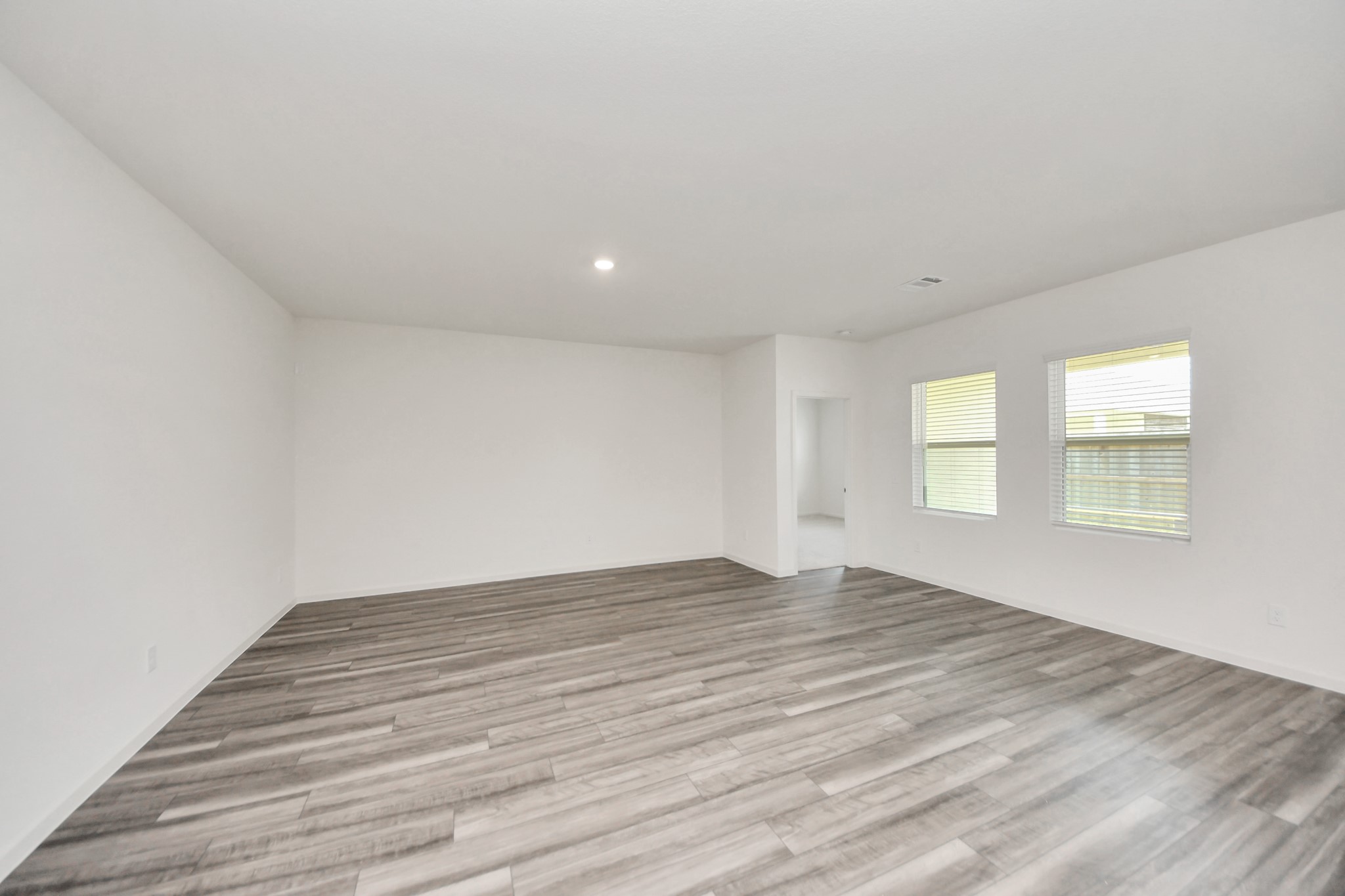 10307 Costa Ter Drive Rosharon, TX 77583 - Photo 23 of 49 a view of an empty room with wooden floor and a window